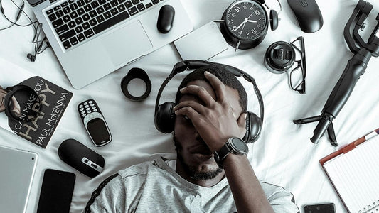 man wearing headset surrounded by gadgets